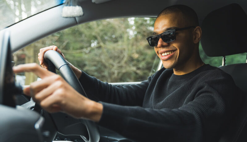 A woman staying cool while driving in hot conditions