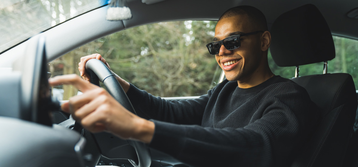 A woman staying cool while driving in hot conditions